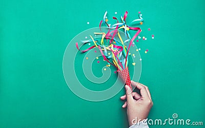 Hand holding colorful confetti,streamers. Stock Photo