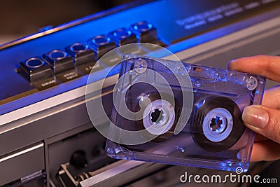 Hand holding compact audio cassette tape - closeup Stock Photo