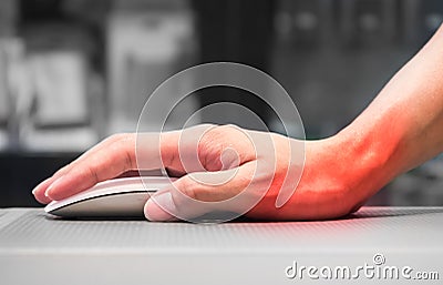 Hand holding computer mouse having wrist pain Stock Photo