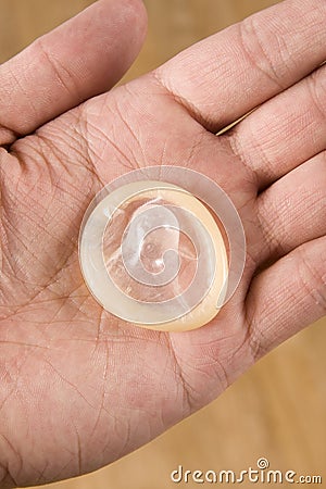 Hand holding condom Stock Photo