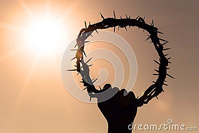 Hand holding crown of christ, concept of resurrection of christ, catholicism Stock Photo