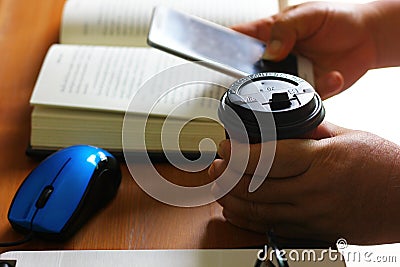 Hand holding delivery copy cup. student reading book for long time drink coffee to refresh Stock Photo