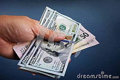 Hand is holding dollar banknotes. Loan and borrowing. Stock Photo