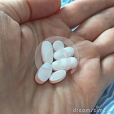 Hand holding daily dose of medicine Stock Photo