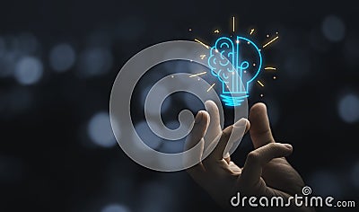 Hand holding drawing virtual lightbulb with brain on bokeh background for creative and smart thinking idea concep Stock Photo