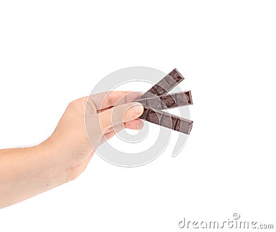 Hand holding foiled dark chocolate bars. Stock Photo
