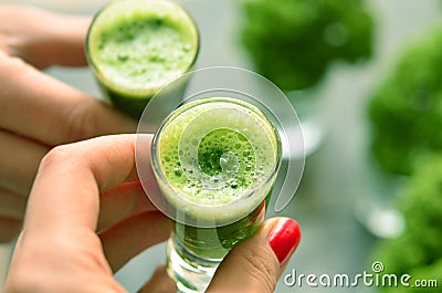 Hand holding a glass with kale coctail Stock Photo