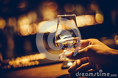 Hand holding a Glencairn single malt whisky glass Stock Photo