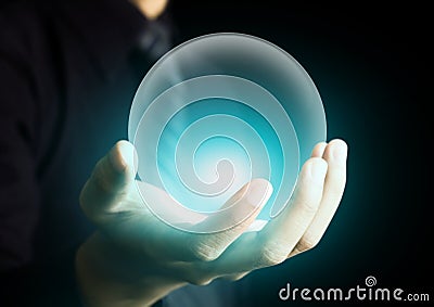 Hand holding a glowing crystal ball Stock Photo