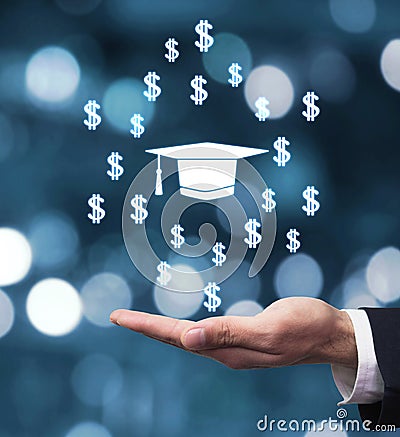 Hand holding Graduation cap with dollar signs Stock Photo