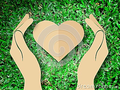 Hand holding heart love the nature symbol Grass background Stock Photo