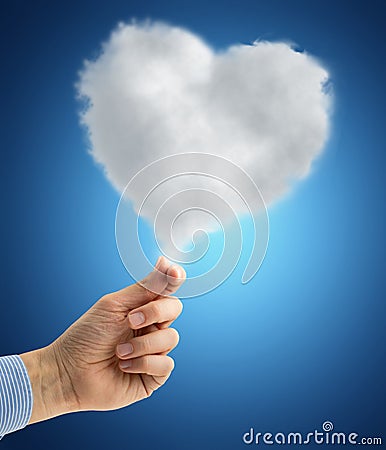 Hand holding a heart-shaped cloud Stock Photo