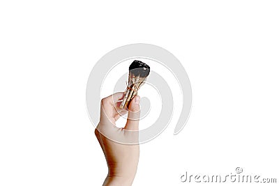 Hand holding herb bundle of dried sage smudge stick. Isolated image on white background Stock Photo