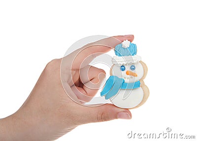 Hand holding home made snowman sugar cookie isolated Stock Photo