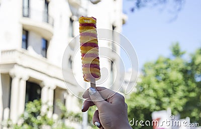 A hand holding ice cream at street. Stock Photo