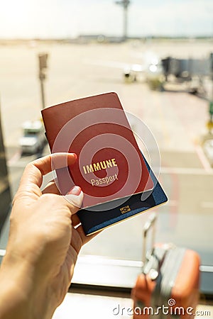 Hand is holding immune passport vaccine document. Stock Photo