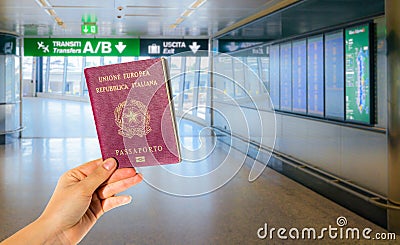 A hand holding an Italian passport Stock Photo