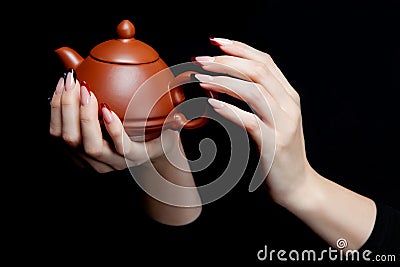 Hand holding a Japanese ceramic teapot with lid Stock Photo