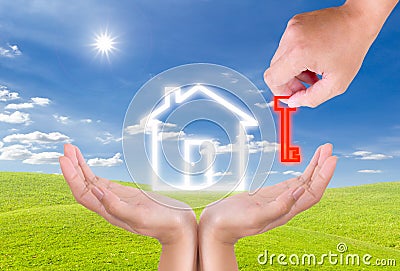 Hand holding key for house icon Stock Photo
