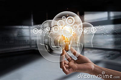 Hand holding light bulb and cog inside. Idea and imagination. Stock Photo