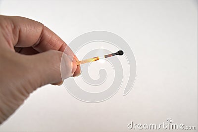 Burning matchstick on hand isolated on white Stock Photo