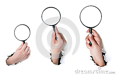 Hand holding a magnifying glass Stock Photo