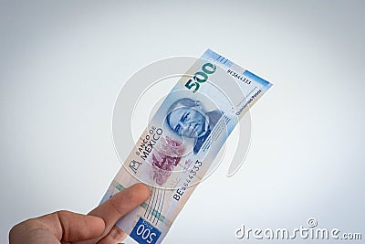 Hand holding mexican peso of 500 Stock Photo