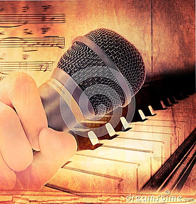 Hand holding microphone and piano Stock Photo
