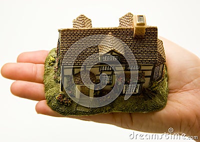 Hand holding minature of house Stock Photo