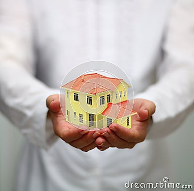 Hand holding miniature house. housing loan concept Stock Photo