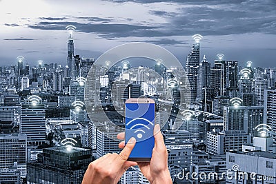 Hand holding mobile phone with wifi network connection network. Stock Photo
