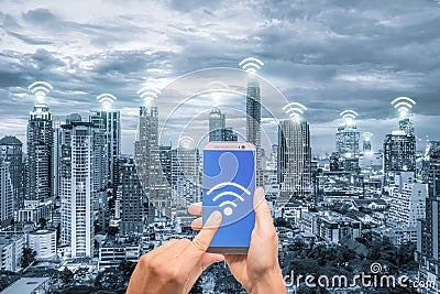 Hand holding mobile phone with wifi network connection network. Stock Photo