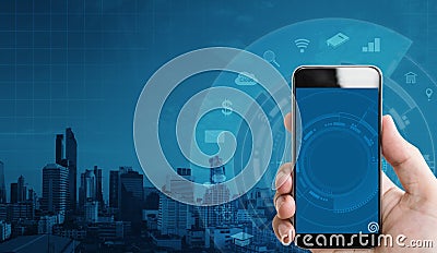 Hand holding mobile smart phone, and application icons technology with building background Stock Photo