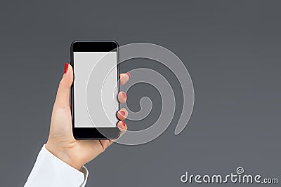 Hand holding mobile smart phone isolated on a gray background Stock Photo