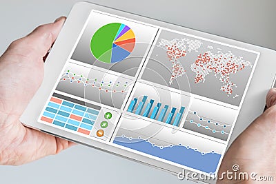 Hand holding modern tablet or mobile device with analytics dashboard Stock Photo