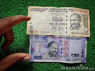 Hand holding of new and old Indian hundred rupees notes. Stock Photo