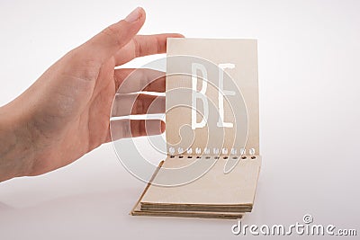 Hand holding a notebook with wording be Stock Photo