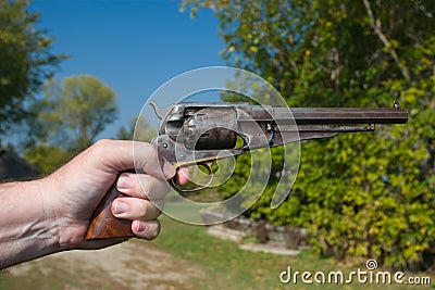 Hand Holding Old Gun Stock Photo