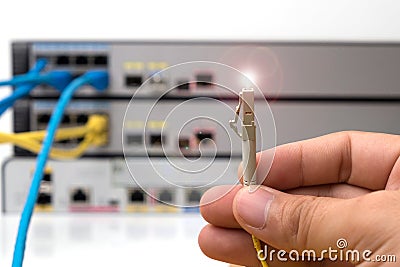 hand holding optic fiber cables with connectors Stock Photo