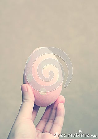 Hand holding painted easter egg with retro filter Stock Photo