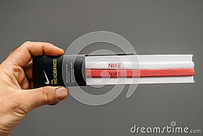 An hand holding a pair of new Nike headbands Editorial Stock Photo