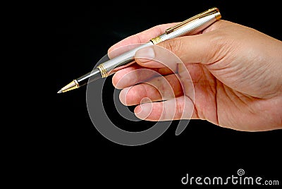 A hand holding a pen Stock Photo