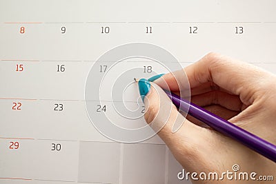 Hand holding pencil on calendar for making appointment importa Stock Photo