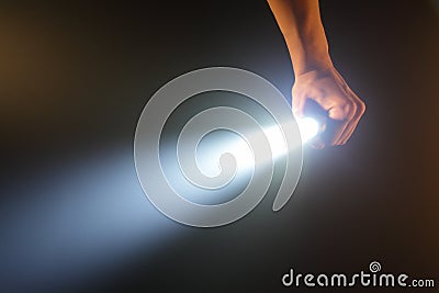 Hand holding pocket flashlight Stock Photo