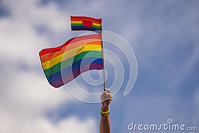 Hand holding rainbow gay flag, symbol of lgbt people, diversity of genders love. Lgbtq community pride month. Flag lgbt Stock Photo