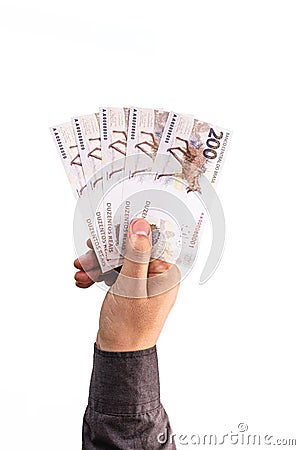 Hand holding 200 reais bills, Brazilian money, fgts concept, emergency aid portion, or economy of brazil Stock Photo