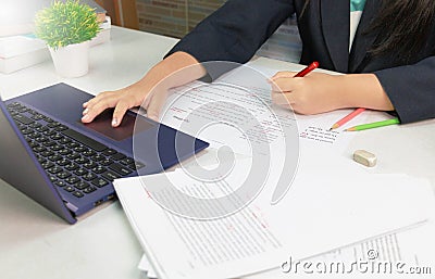 Hand holding red pen over proofreading paper Stock Photo