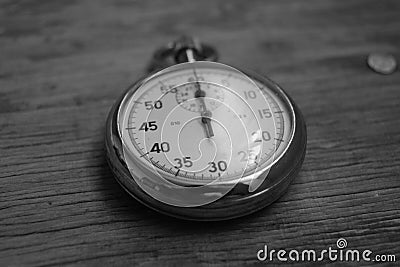 Hand holding retro stopwatch in black white Stock Photo