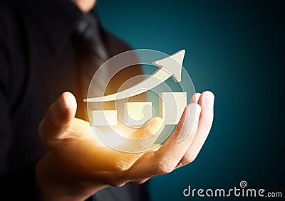 Hand holding a rising arrow,business growth. Stock Photo