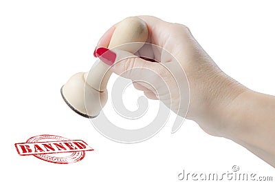 Hand holding a rubber stamp with the word banned Stock Photo